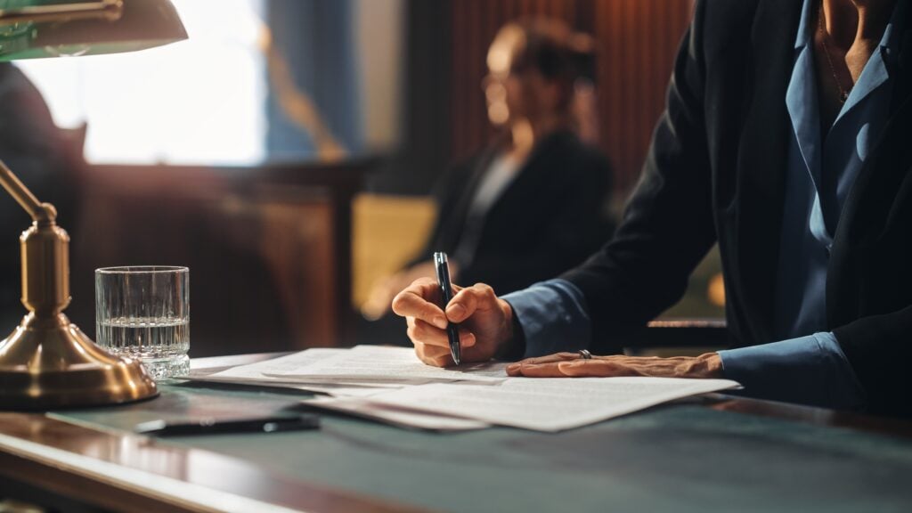 Young Lawyer choosing a practice path with courtroom and documents in background.