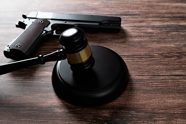 Gun and gavel on the table.